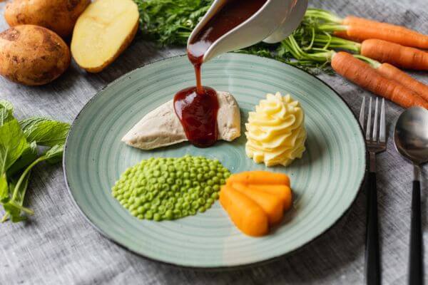 chicken on a plate served with vegetables